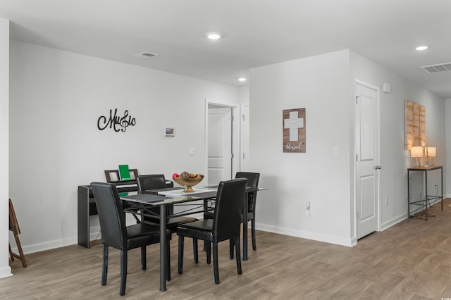 dining space with light hardwood / wood-style flooring