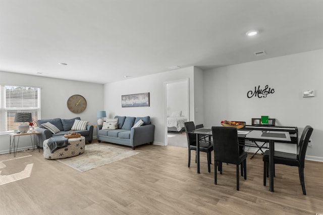 dining area with light hardwood / wood-style floors