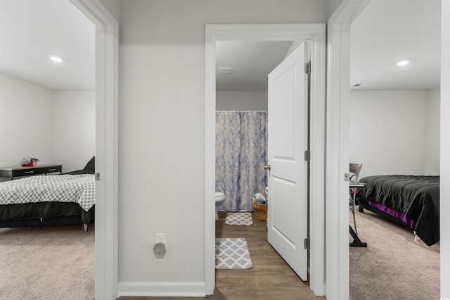 carpeted bedroom featuring ensuite bath