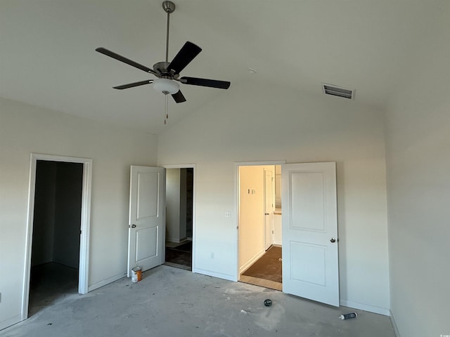 unfurnished bedroom with unfinished concrete floors, visible vents, high vaulted ceiling, and connected bathroom