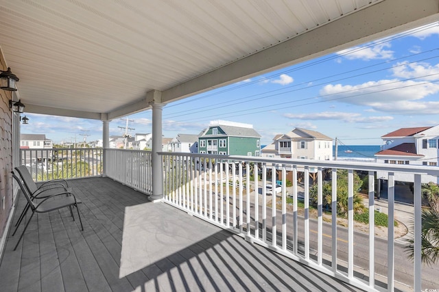 wooden terrace featuring a water view