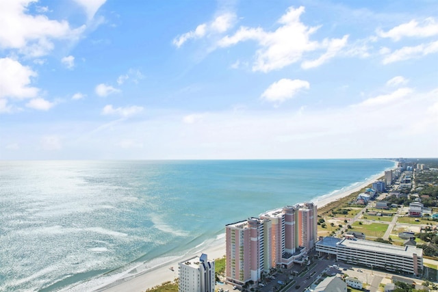 drone / aerial view featuring a water view and a beach view