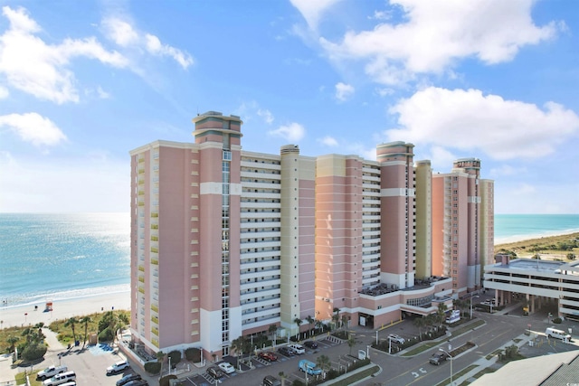 view of property with a water view and a view of the beach