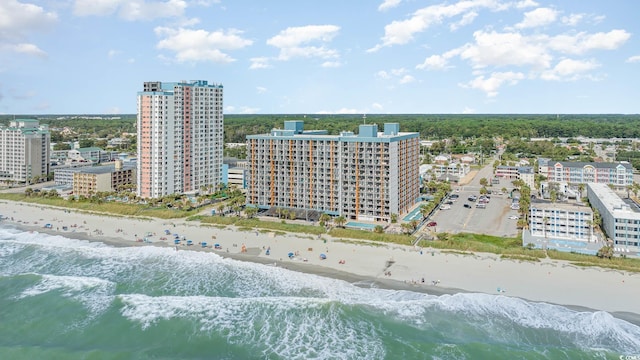 birds eye view of property with a water view and a beach view