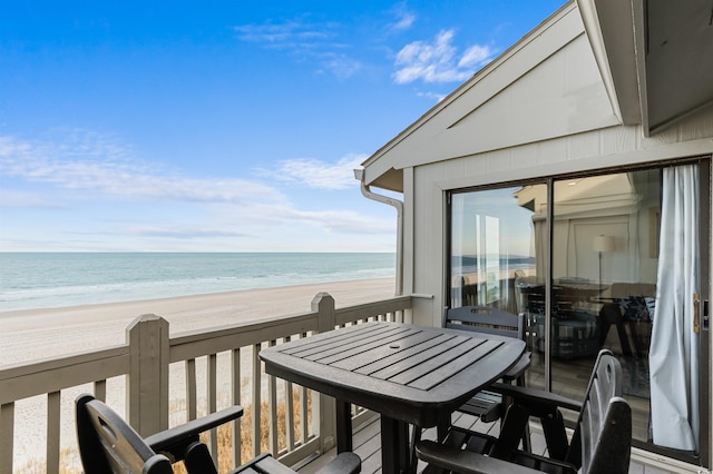 balcony featuring a water view and a beach view