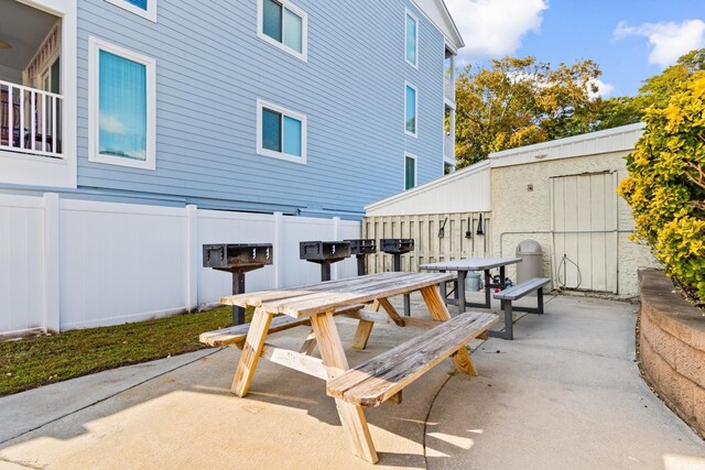 view of patio with a storage unit