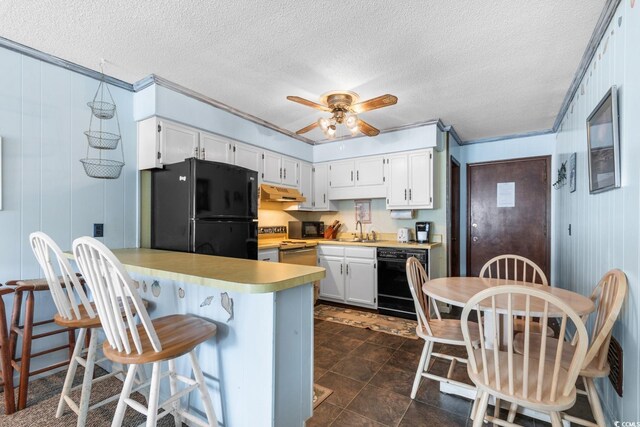 kitchen with a breakfast bar area, kitchen peninsula, white cabinetry, and black appliances