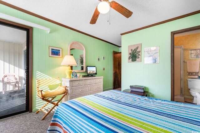 carpeted bedroom with a textured ceiling, ensuite bath, ceiling fan, and ornamental molding