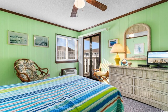 carpeted bedroom featuring a wall unit AC, ceiling fan, crown molding, and wood walls