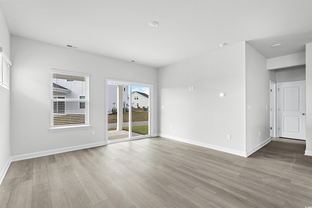 unfurnished room with light wood-type flooring