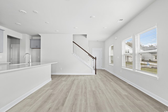 unfurnished living room featuring light wood-type flooring