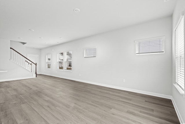 unfurnished room with light wood-type flooring