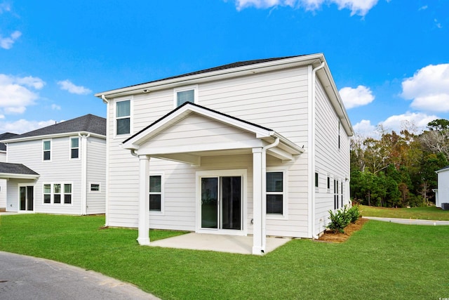 rear view of property featuring a patio area and a lawn