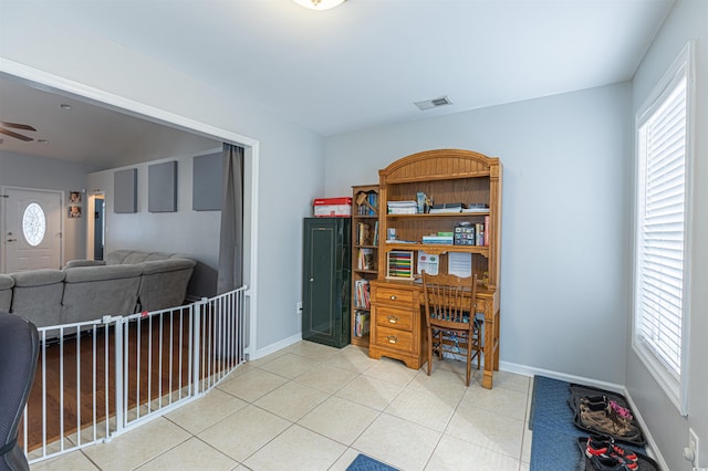 tiled home office with baseboards, visible vents, and ceiling fan