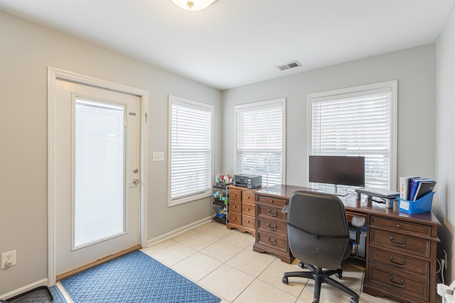 office with light tile patterned flooring, visible vents, and baseboards