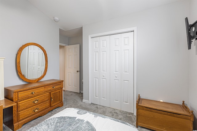 bedroom featuring a closet and light carpet