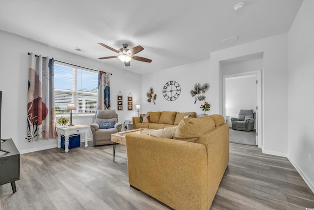 living room featuring ceiling fan and hardwood / wood-style floors