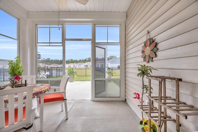 sunroom / solarium featuring ceiling fan