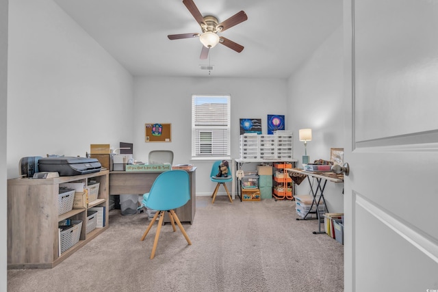 carpeted office space with ceiling fan