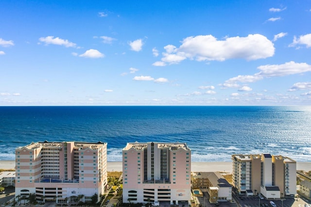 birds eye view of property featuring a beach view and a water view