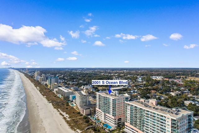 bird's eye view featuring a water view and a beach view