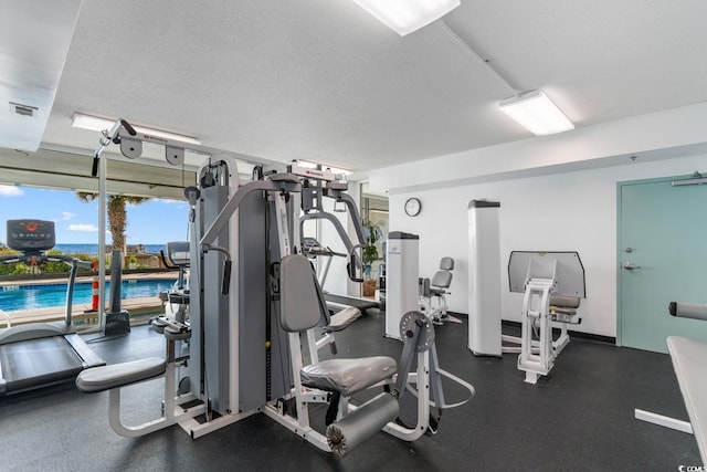 exercise room featuring a textured ceiling