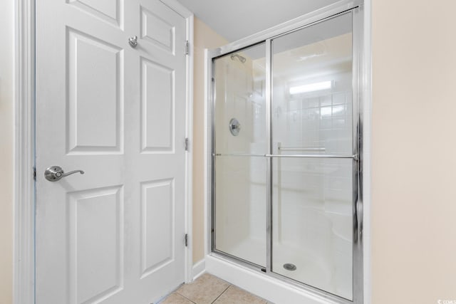 bathroom with tile patterned floors and an enclosed shower