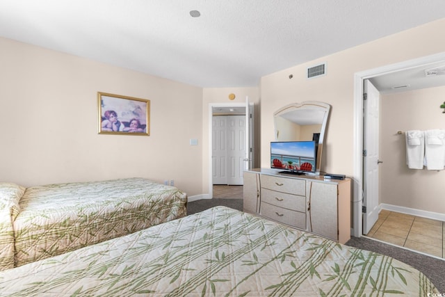 carpeted bedroom featuring a textured ceiling