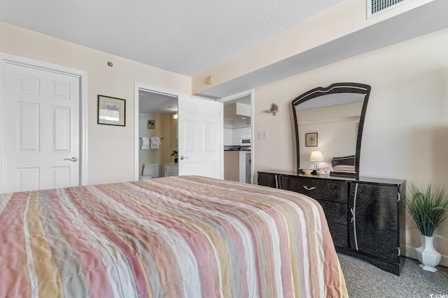 bedroom featuring carpet floors and a textured ceiling