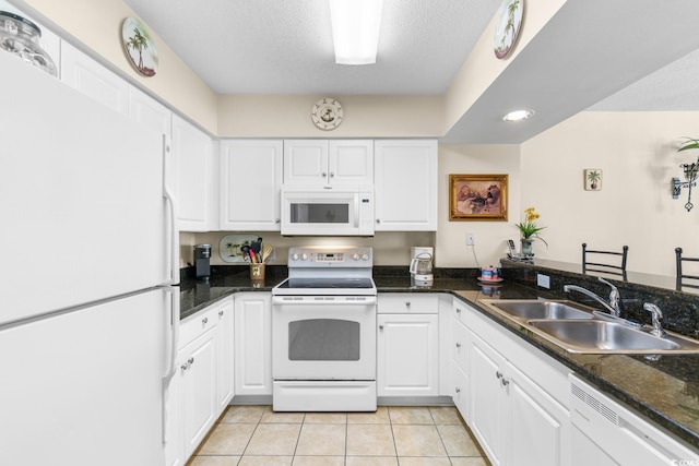 kitchen featuring white cabinetry, sink, and white appliances