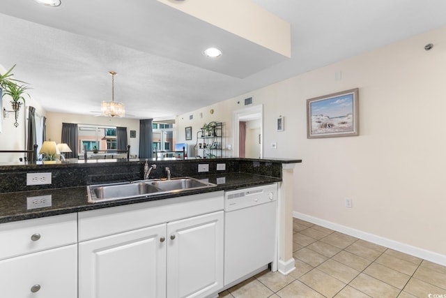 kitchen featuring white cabinetry, dishwasher, sink, a notable chandelier, and decorative light fixtures