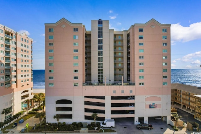 view of property featuring a water view and a beach view