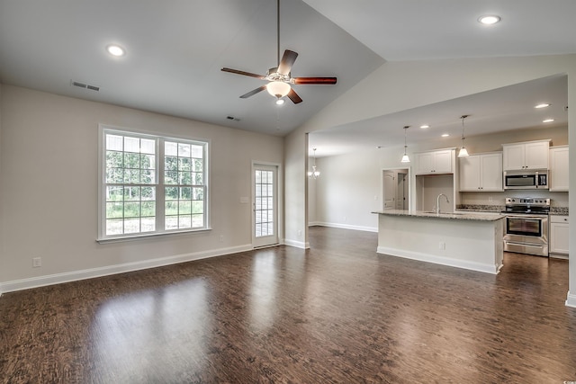 unfurnished living room with dark hardwood / wood-style floors, ceiling fan, sink, and high vaulted ceiling