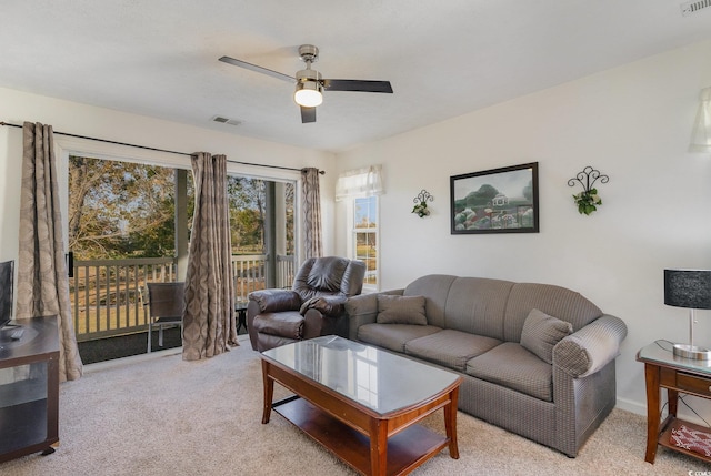 living room featuring light carpet and ceiling fan