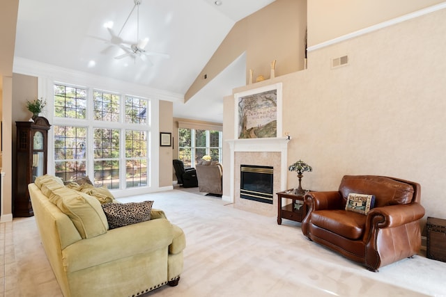 living room with high vaulted ceiling, plenty of natural light, crown molding, and ceiling fan