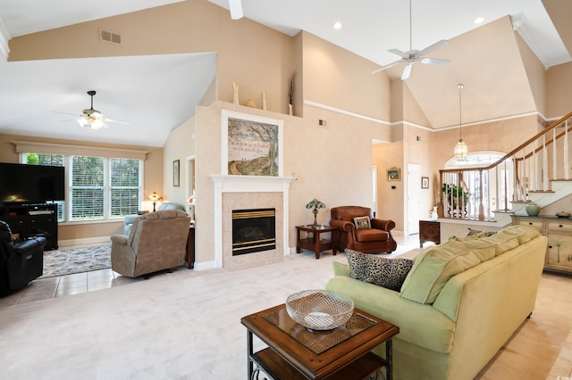 carpeted living room featuring ceiling fan, a fireplace, and high vaulted ceiling