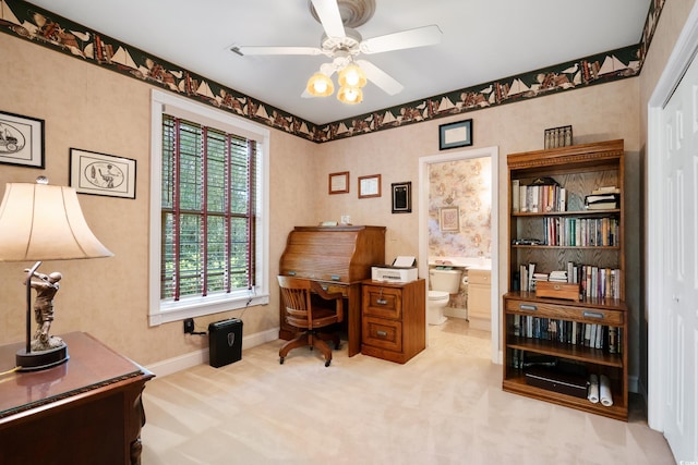 carpeted office space with ceiling fan