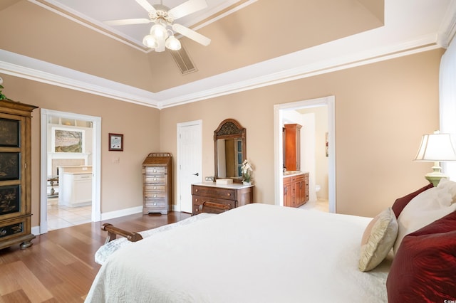 bedroom with light wood-type flooring, ensuite bath, ceiling fan, and ornamental molding