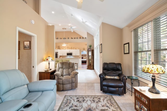 living room with ceiling fan, light tile patterned floors, and high vaulted ceiling