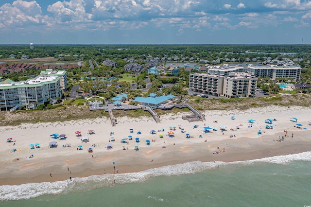 bird's eye view featuring a water view and a beach view