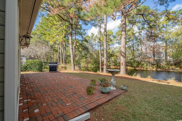 view of patio / terrace featuring a water view and area for grilling