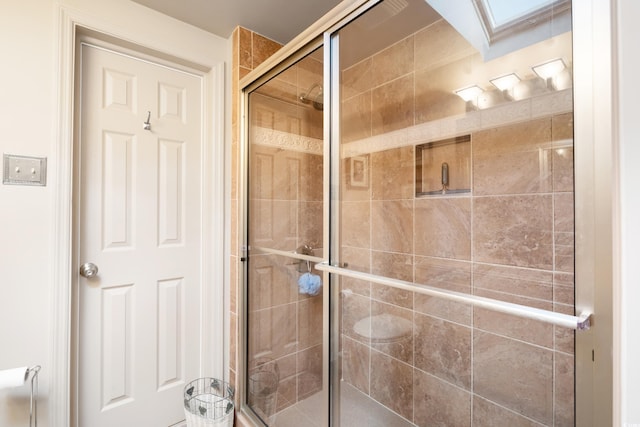 bathroom with a shower with shower door