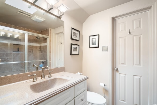 bathroom featuring toilet, vanity, lofted ceiling, and walk in shower