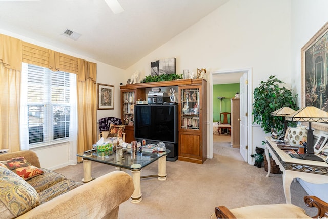 living room with light carpet and high vaulted ceiling