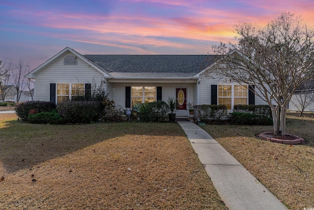 ranch-style house featuring a lawn