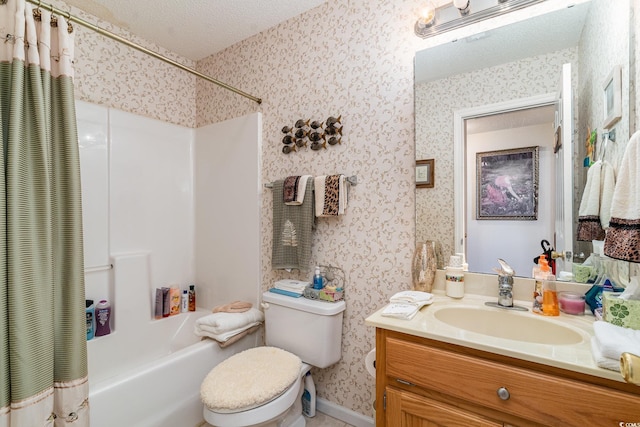 full bathroom featuring vanity, toilet, a textured ceiling, and shower / tub combo