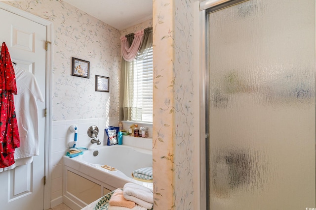 bathroom featuring separate shower and tub