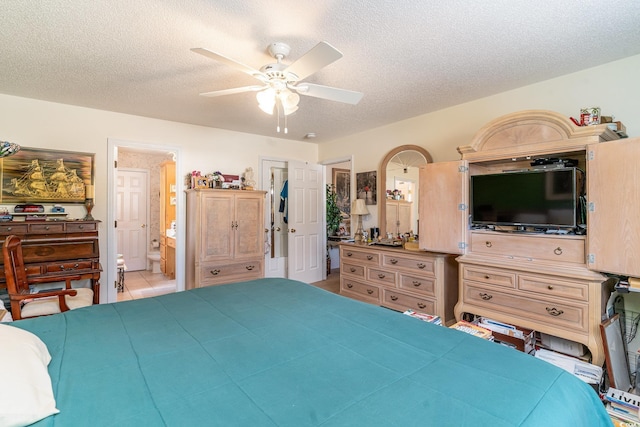 bedroom featuring a textured ceiling, connected bathroom, ceiling fan, and light tile patterned flooring