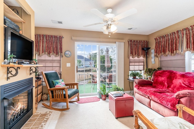 living room with a textured ceiling and ceiling fan