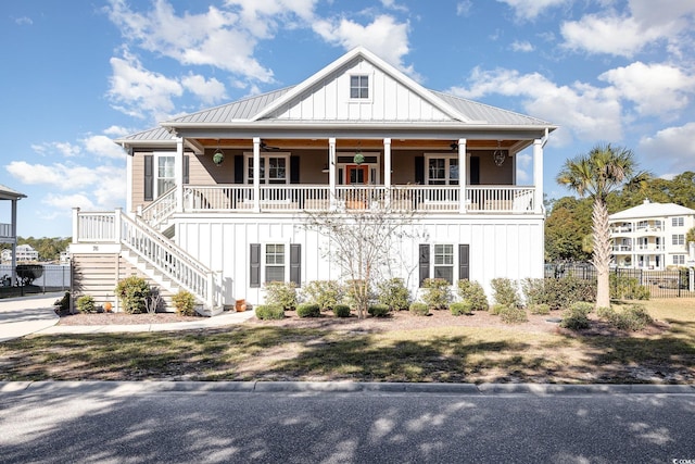 coastal inspired home featuring covered porch and ceiling fan